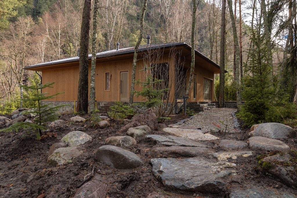 Exterior view of the SPA wellness building at Chalet Alpino Resort set within an alpine forest landscape