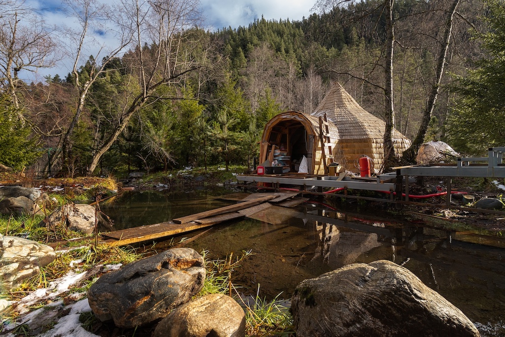 Waterfront sauna pavilion at the SPA in Chalet Alpino Resort set beside a natural alpine stream