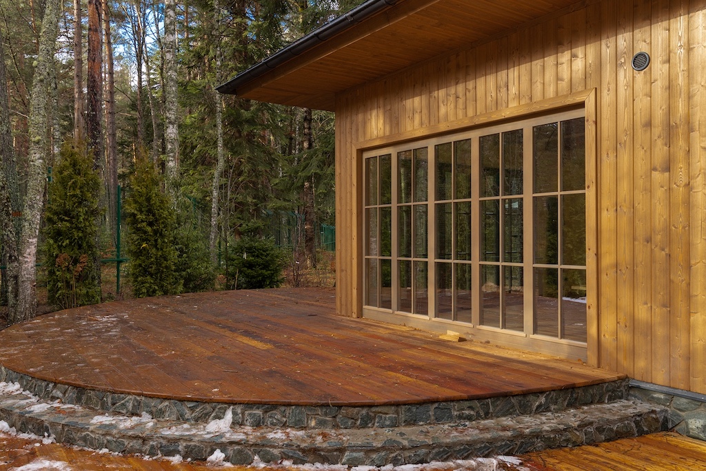 Exterior terrace of the SPA building at Chalet Alpino Resort featuring timber façade and panoramic glazing