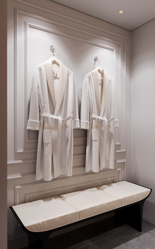 Luxury hotel suite bathroom interior design by Claire Dominics Buro featuring bespoke wall paneling and curated hospitality amenities