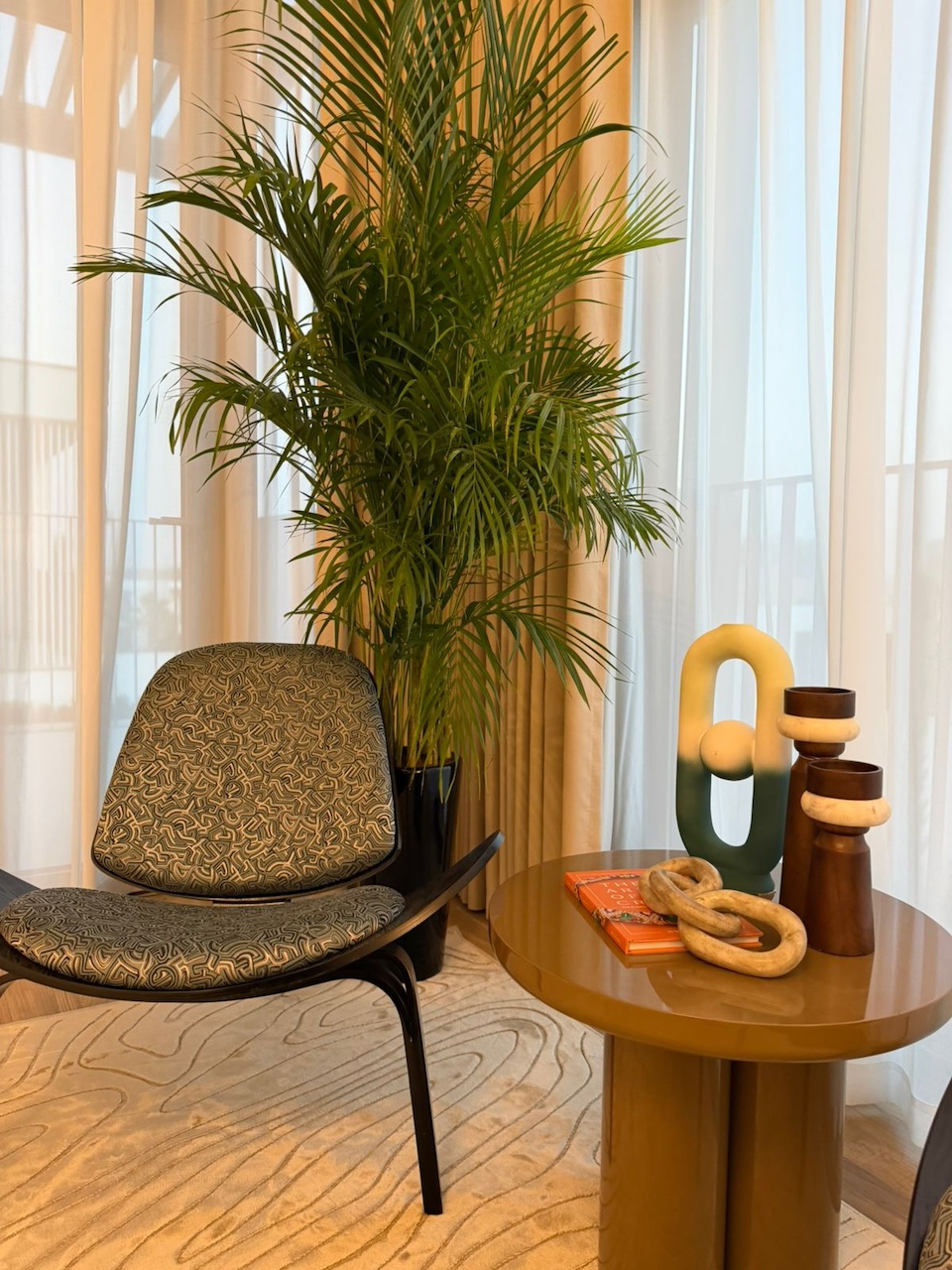 Luxury villa bedroom seating area interior design in Dubai by Claire Dominics Buro featuring bespoke accent chair and curated decor styling