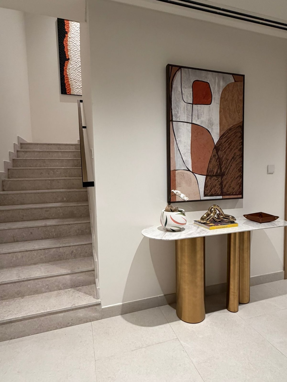 Luxury villa entrance hall interior design in Dubai by Claire Dominics Buro featuring bespoke marble console and architectural staircase