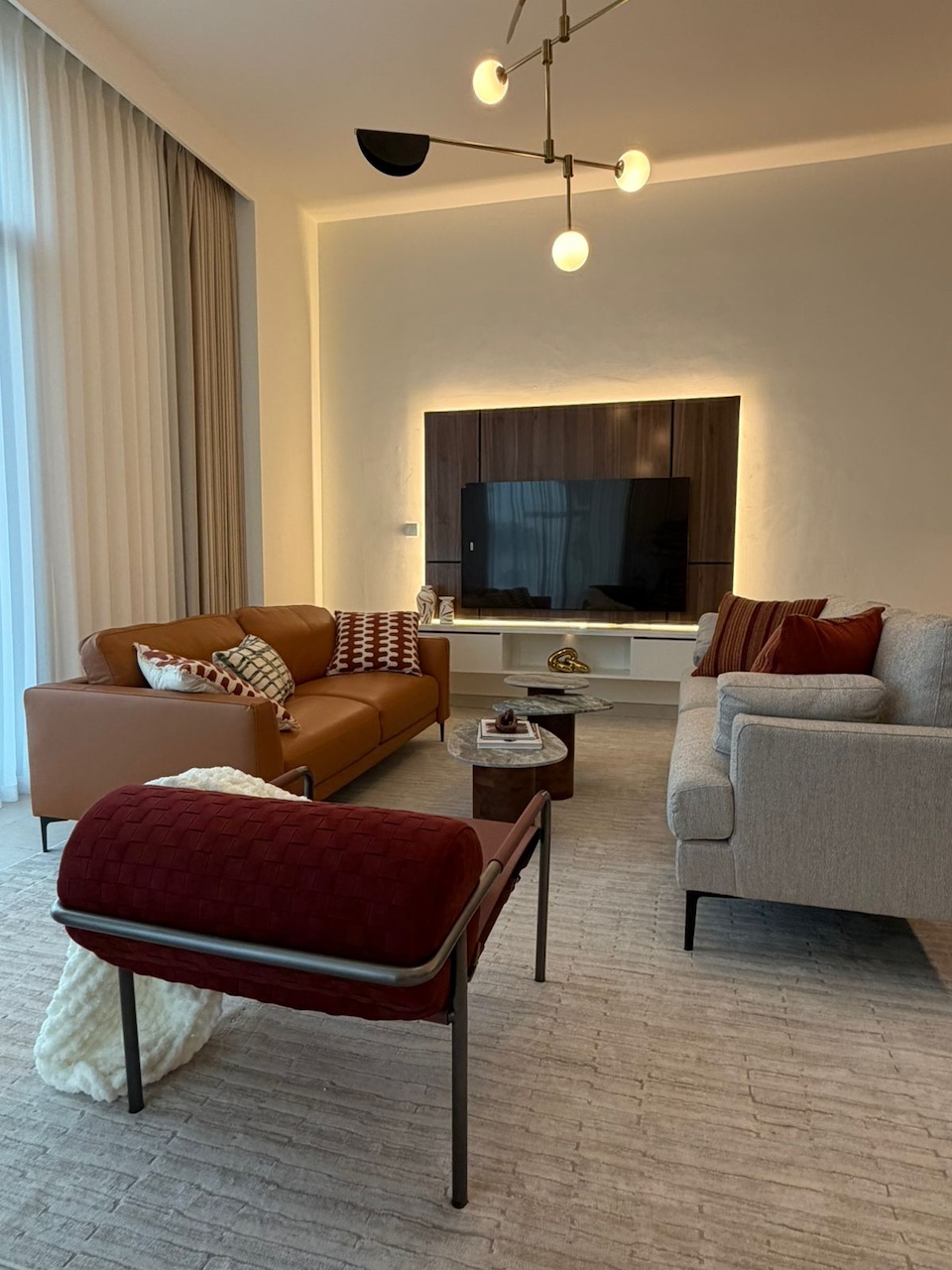 Luxury living room interior design in Tilal Al Furjan Dubai villa with bespoke sofas, leather seating and contemporary lighting by Claire Dominics Buro